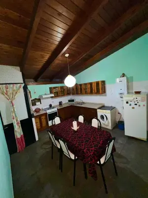 a kitchen with a table and chairs in a room at La roca in Villa Carlos Paz