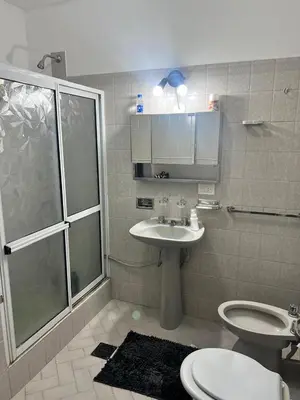 a bathroom with a shower and a sink and a toilet at Carlos Paz, casa ideal para tus vacaciones soñadas in Villa Carlos Paz