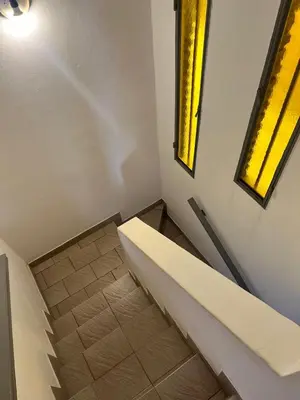 a staircase in a room with a yellow window at Carlos Paz, casa ideal para tus vacaciones soñadas in Villa Carlos Paz