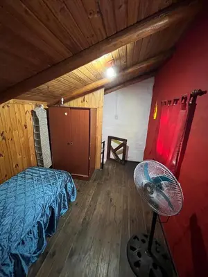 a bedroom with a bed and a fan in a room at La Morada in Mina Clavero