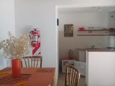 a kitchen and dining room with a table and chairs at Arcadia in Merlo