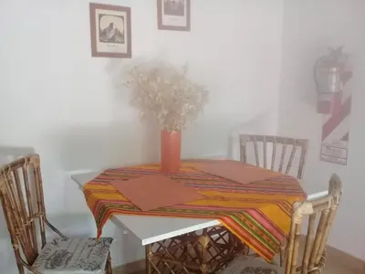 a table with a vase on top of it at Arcadia in Merlo