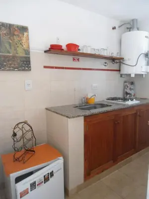 a kitchen with a sink and a stove top oven at Arcadia in Merlo