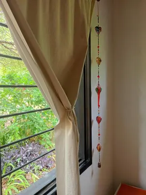 a window with curtains in a room at Arcadia in Merlo