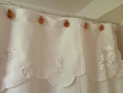 a white shower curtain with butterflies on it at Arcadia in Merlo