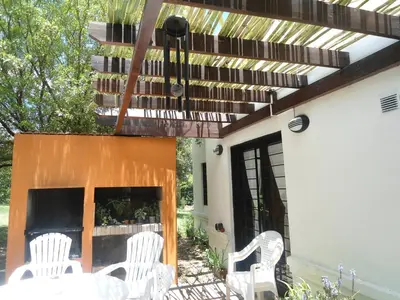 a patio with white chairs and a piano at Arcadia in Merlo