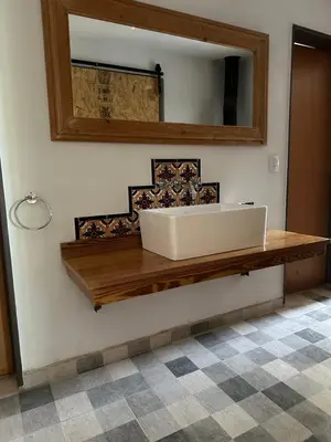 a bathroom with a sink and a mirror on the wall at Casita de los Reartes in Los Reartes