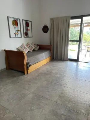 a bedroom with a bed and a tiled floor at Casita de los Reartes in Los Reartes