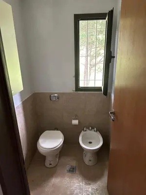 a small bathroom with a toilet and a sink at Casita de los Reartes in Los Reartes