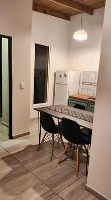 a kitchen with a table and chairs in a room at Complejo MAS vista in San Antonio de Arredondo