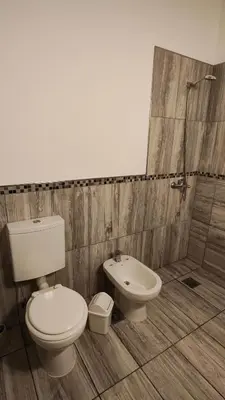 a bathroom with a toilet and a sink at Complejo MAS vista in San Antonio de Arredondo