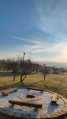 a park with a fire pit in the middle of a field at Complejo MAS vista in San Antonio de Arredondo