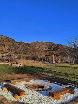 a park with a pond with a playground in the background at Complejo MAS vista in San Antonio de Arredondo