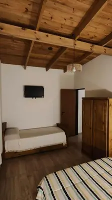 a bedroom with a bed and a tv on the wall at Complejo MAS vista in San Antonio de Arredondo
