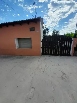 a building with a gate and a fence at Don Nene in Villa Cura Brochero