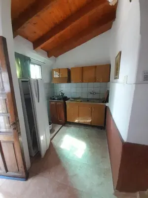 a kitchen with wooden cabinets and stainless steel appliances at Don Nene in Villa Cura Brochero