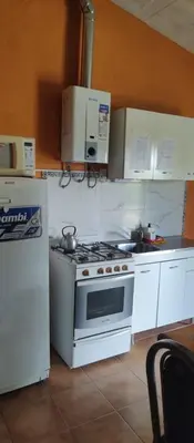 a kitchen with a stove and a refrigerator at Tia Clau 1 in Villa Cura Brochero