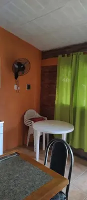 a room with a table and a green curtain at Tia Clau 1 in Villa Cura Brochero