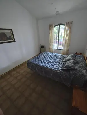 a bedroom with a bed and a window at Casa Villa Carlos Paz in Villa Carlos Paz