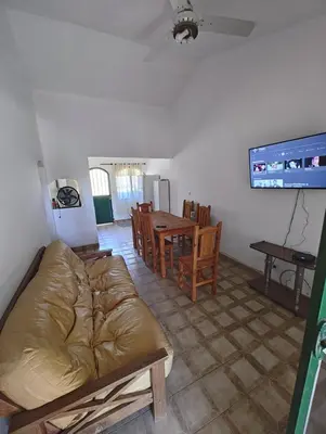 a living room with a couch and a table at Casa Villa Carlos Paz in Villa Carlos Paz