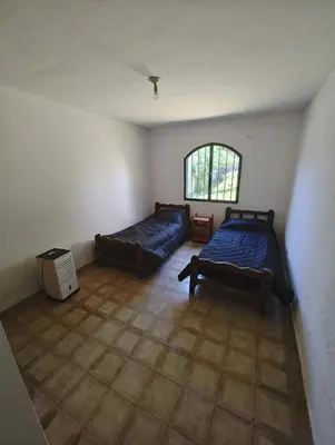 a room with two beds and a window at Casa Villa Carlos Paz in Villa Carlos Paz
