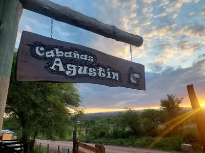 a sign hanging from the side of a building at Cabaña AGUSTIN in Amboy