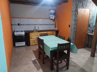a small kitchen with a table and a stove at Cabaña AGUSTIN in Amboy