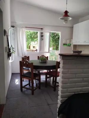 a kitchen and dining room with a table and chairs at Kairós in Tanti