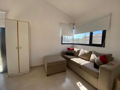 a living room with a couch and a window at casa con pileta cerca de pekos y carlos paz in Villa Carlos Paz