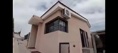 a white house with a window on top of it at casa con pileta cerca de pekos y carlos paz in Villa Carlos Paz