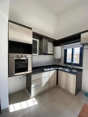 a kitchen with stainless steel appliances in a room at casa con pileta cerca de pekos y carlos paz in Villa Carlos Paz