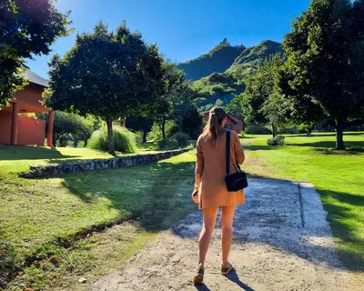 a woman is walking down a dirt road at Cabañas Balcon al Champaqui in Villa General Belgrano