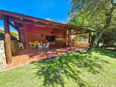 a patio with a table and chairs in a yard at Cabañas Balcon al Champaqui in Villa General Belgrano