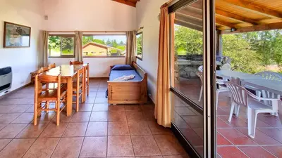 a room with a table and chairs and a dining room at Cabañas Balcon al Champaqui in Villa General Belgrano