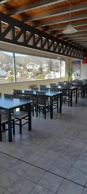 a row of tables and benches in a cafeteria at Miralejos 2 in Villa Carlos Paz
