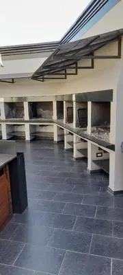 an empty building with a tile floor and tables at Miralejos 2 in Villa Carlos Paz