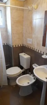 a bathroom with a toilet and a sink at Miralejos 2 in Villa Carlos Paz
