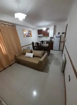 a living room with a couch and a table at Miralejos 2 in Villa Carlos Paz