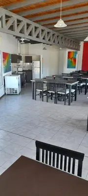 a room with benches and tables in a building at Miralejos 2 in Villa Carlos Paz