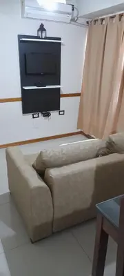 a living room with a couch and a flat screen tv at Miralejos 2 in Villa Carlos Paz