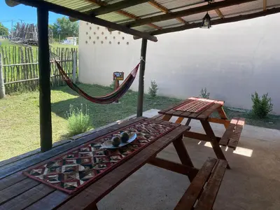 a hammock and a picnic table on a patio at Casitas del Champaqui in Villa Yacanto