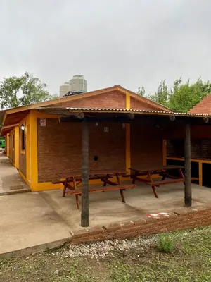 a building with picnic tables in front of it at Casitas del Champaqui in Villa Yacanto