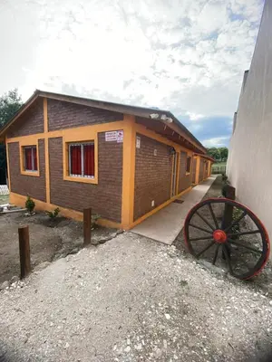 a small building with a wheel in front of it at Casitas del Champaqui in Villa Yacanto
