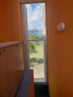 an open door to a window with a view at Miradores del Dique in San Francisco del Monte de Oro