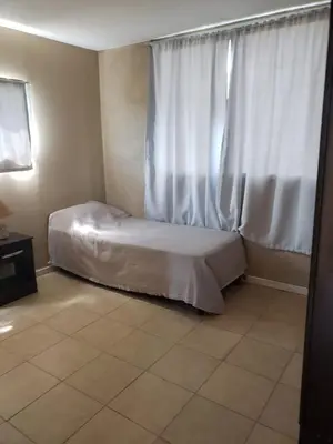 a small bedroom with a bed and a window at Miradores del Dique in San Francisco del Monte de Oro