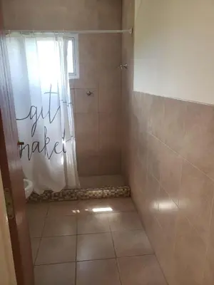 a bathroom with a shower with a shower curtain at Miradores del Dique in San Francisco del Monte de Oro