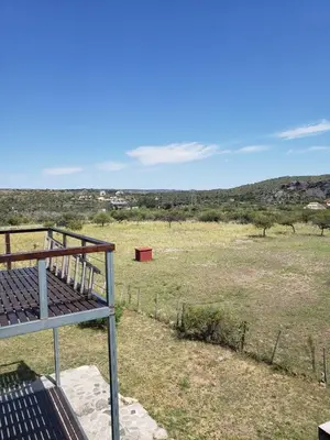 a view of a field from the balcony of a house at Miradores del Dique in San Francisco del Monte de Oro