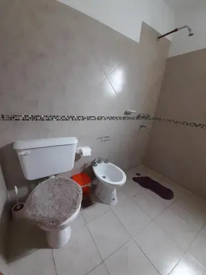 a bathroom with a toilet and a bidet at Departamento Carolina in Villa Carlos Paz