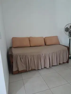 a couch sitting in a corner of a room at Departamento Carolina in Villa Carlos Paz