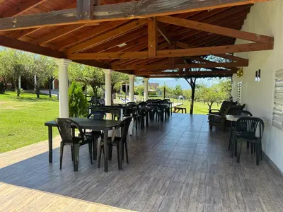 a group of tables and chairs on a patio at Cabañas AdamiS 5 in Villa Cura Brochero